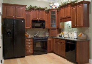 Remodeled cherry-wood kitchen with black appliances