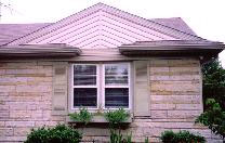 Stone-front home with custom white window casing trim